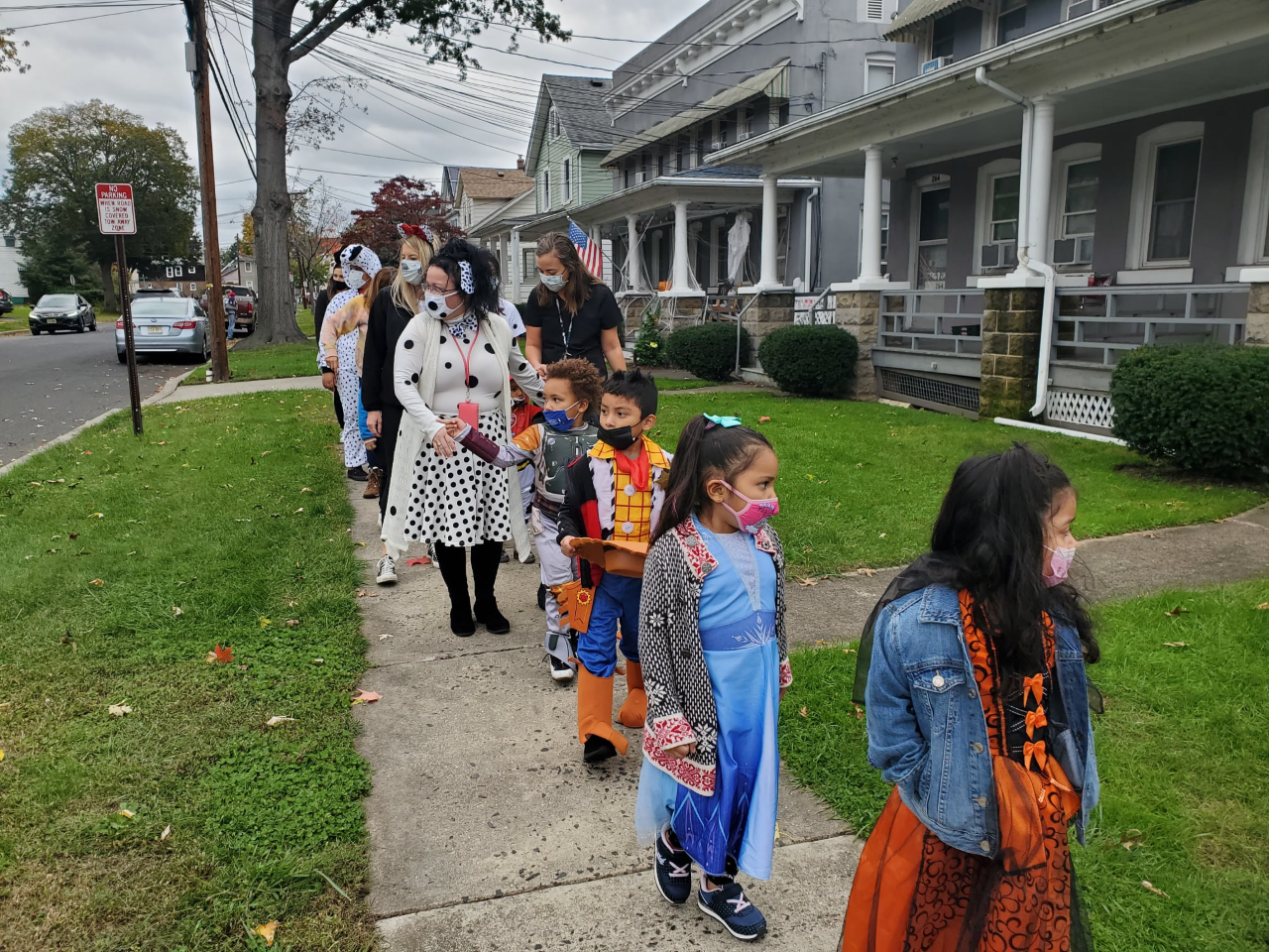 Students in costumes stand in line for Halloween parade